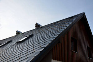 gray roof tiles with windows square slate template. square grid pattern. the lower edge of the roof is formed by a metal strip for framing  better tearing off  layer of snow heat transfer through  , window