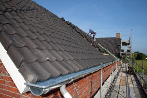 Roofer is working hard on a roof.If you want more images with a roofer at work please click here.